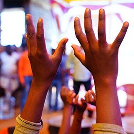 Close up of child's hands in the air