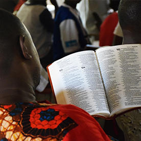 African man reading Bible