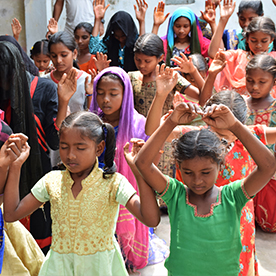 Indian children worshipping