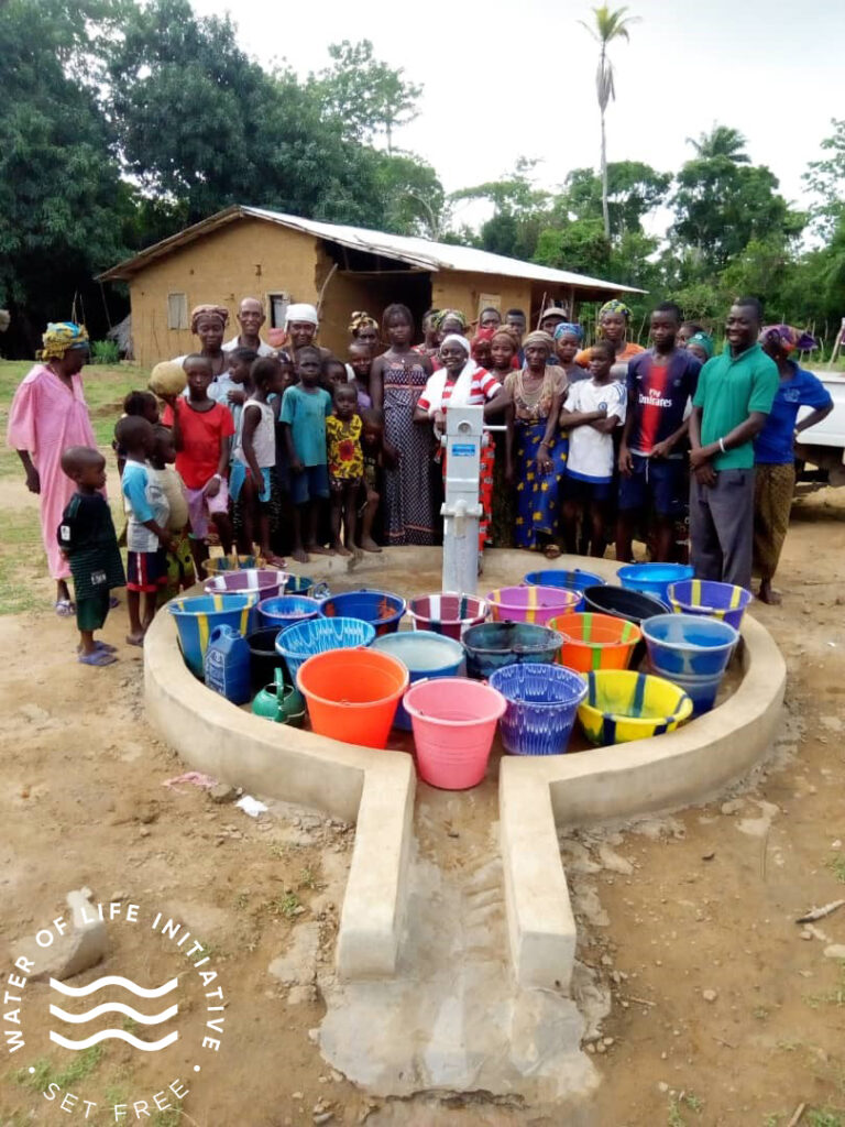 Villagers in front of a new water well