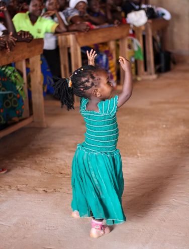 Child dancing in village church