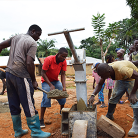 African men drilling well